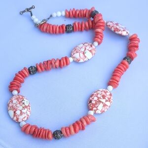 vintage-style beaded necklace w/orange coral beads, white and orange stones.